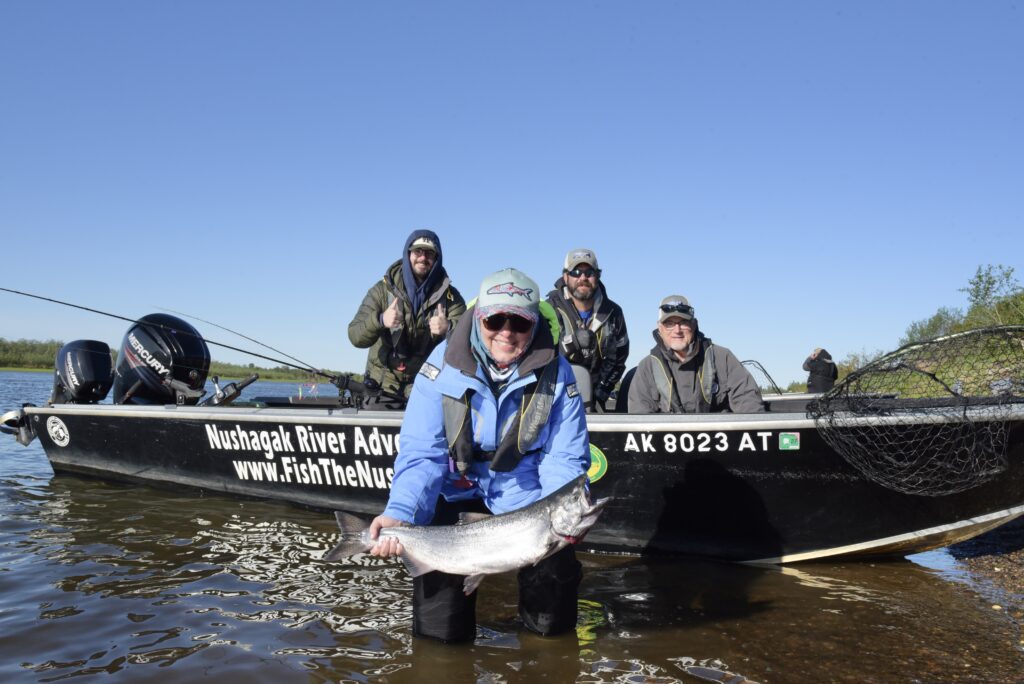 Angler holding a bright king salmon in the Nushagak River at Fish The Nush