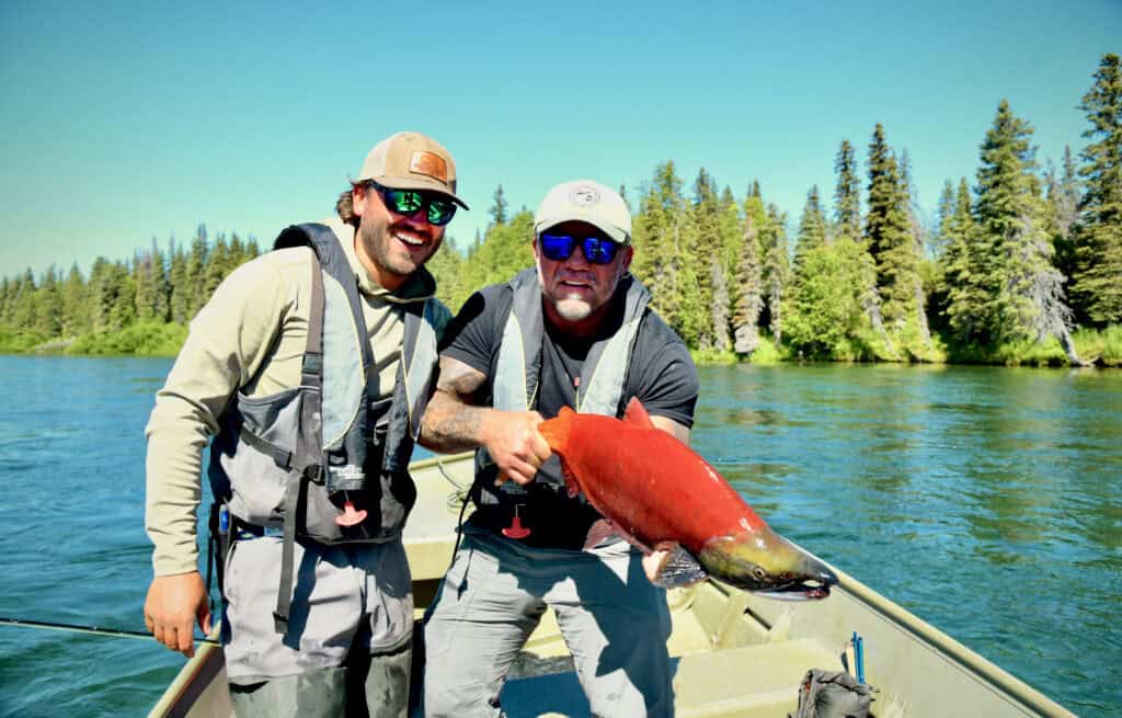 Fly-Outs Guests with a sockeye at Lake Chauekuktuli