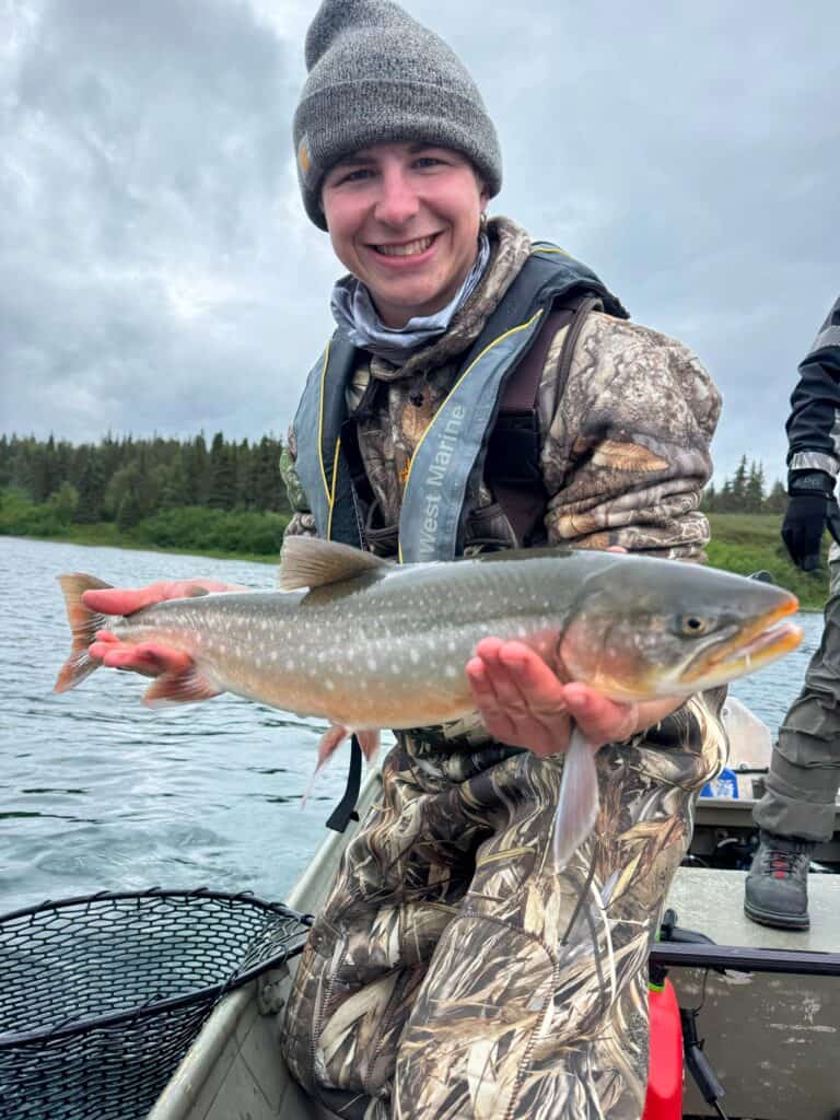 Man holding a large trout.