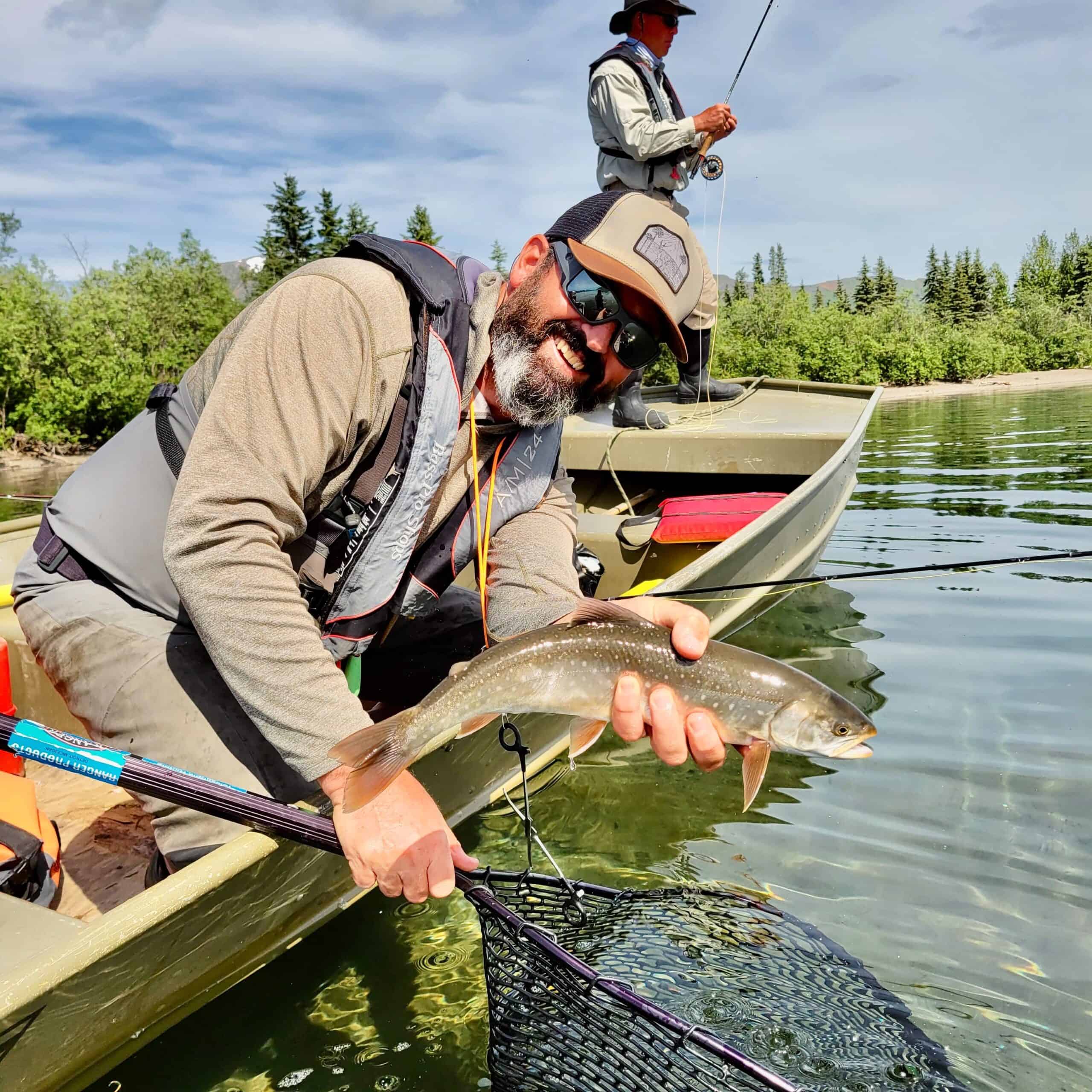 Man holds fresh fish, fly fishing