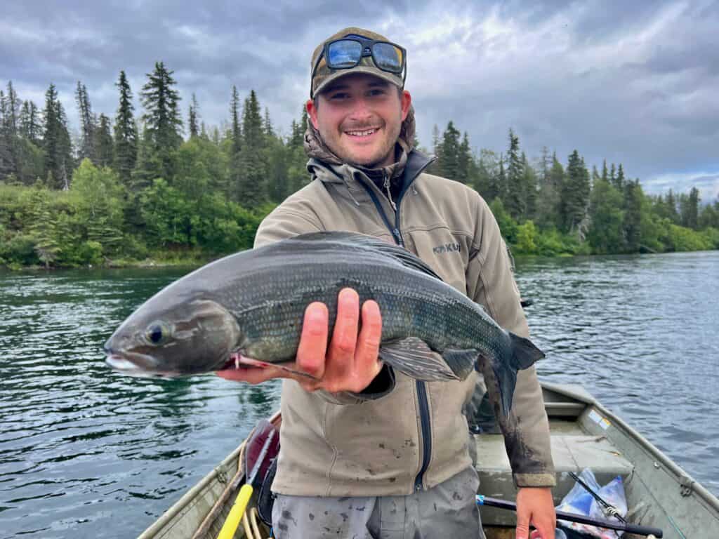 Fisherman holding a large fish.
