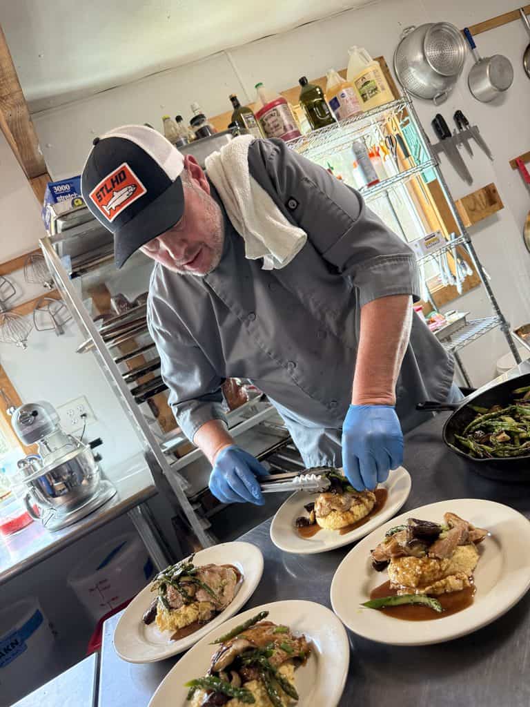 Chef plates food with gloves